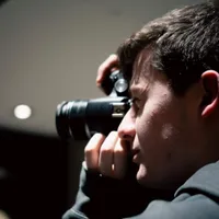 Headshot of Nathan Jacobson holding a camera
